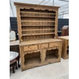 A LARGE VICTORIAN STYLE PINE DRESSER WITH OPEN BASE, THREE DRAWERS AND UPPER PLATE RACK