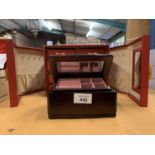 A RED AND GOLD PORTABLE SIX DRAWER JEWELLERY CASE AND A SMALL WOODEN JEWELLERY BOX