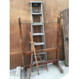 A VINTAGE WOODEN CLOTHES RAIL ON CASTORS, A WOODEN EASEL AND A SET OF SIX RUNG STEP LADDERS