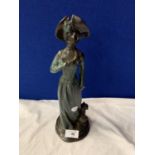 A BRONZE FIGURINE AN OF EDWARDIAN LADY WITH HER DOG