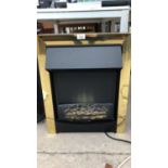 AN ELECTRIC FIRE WITH BRASS SURROUND