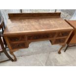 A MID 20TH CENTURY WALNUT DRESSING TABLE ON BALL AND CLAW FEET