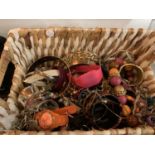 A LARGE QUANTITY OF COSTUME JEWELLERY TO INCLUDE THE STORAGE BASKET