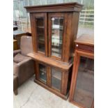 A VICTORIAN WALNUT GLAZED TWO DOOR BOOKCASE ON BASE WITH BEVELLED GLASS, 32" WIDE