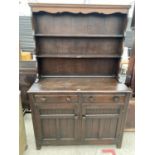 AN OAK DRESSER WITH TWO DOORS, TWO DRAWERS AND UPPER PLATE RACK - 48" WIDE