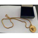 A GOLD PLATED VERSACE MEDALLION WITH CHAIN