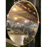 A LARGE ROUND DECORATIVE VINTAGE BEVELLED MIRROR