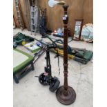 A WOODEN STANDARD LAMP BASE TOGETHER WITH GOLF BAG CADDY - IN W/O
