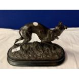 A SPELTER ORNAMENT OF A HUNTING DOG ON A WOODEN PLINTH