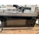 A BLACK AND SILVER MICROWAVE BELIEVED TO BE IN WORKING ORDER BUT NO WARRANTY
