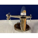 A CHROME MODEL OF A SPITFIRE ON A WOODEN BASE