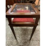 A MAHOGANY FOUR LEGGED DISPLAY CABINET