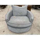 A MODERN CIRCULAR ARMCHAIR ON SWIVEL SUPPORT