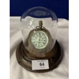 A BRASS POCKET WATCH ON A LEATHER BASE WITH A GLASS DOME