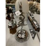 A SILVER COLOURED CRUMB TRAY AND BRUSH ON A BALLERINA STAND