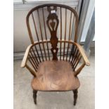 A 19TH CENTURY ELM AND ASH HIGH BACK WINDSOR CARVER ARMCHAIR