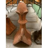A DECORATIVE TERRACOTTA ROOF FINIAL IN THE STYLE OF A CHESS PIECE