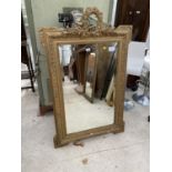 A 19TH CENTURY GILT FRAMED WALL MIRROR, 54x33" WITH FOLIATE DECORATION TO THE TOP RAIL