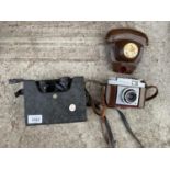 A ZEISS CONTINA CAMERA WITH LEATHER CASE AND A PAIR OF SWALLOW 8 X 30 BINOCULARS WITH CASE