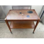 A KVALITET FUNK FORM DESIGN TEAK TROLLEY/TABLE WITH INSET BLACK CIRCLE DESIGNS TOP, 29.5x18"