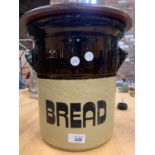 A LARGE STONEWARE BREAD BIN WITH WOODEN LID