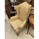 A GEORGIAN STYLE WINGED EASY CHAIR ON FRONT CABRIOLE LEGS