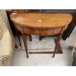 A 19TH CENTURY MAHOGANY INLAID AND CROSSBANDED FOLD-OVER GAMES TABLE ON TAPERED LEGS AND SPADE FEET,
