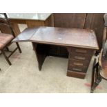 AN EARLY 20TH CENTURY SINGLE PEDESTAL DESK OF SMALL PROPORTIONS, WITH DROP-LEAF