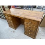 A PINE DESK WITH EIGHT DRAWERS
