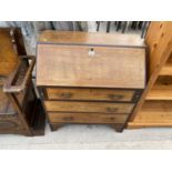 AN INLAID MAHOGANY BUREAU WITH FALL FRONT AND THREE DRAWERS