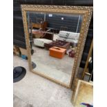 A GILT FRAMED MIRROR