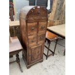 A MODERN INDONESIAN WOOD DOME TOPPED CHEST WITH TWO DOORS AND FOUR DRAWERS