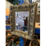 A SQUARE GILT FRAMED MIRROR