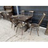 AN OAK DRAW LEAF DINING TABLE AND SIX ERCOL DINING CHAIRS