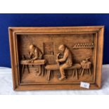 A WOODEN CARVED PICTURE, SIGNED , DEPICTING CARPENTERS