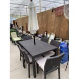 A SIX SEATER RATTAN GARDEN DINING TABLE WITH CHAIRS, SEAT PADS AND CREAM UMBRELLA