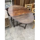 AN OVAL OAK DROP LEAF DINING TABLE ON BARLEY TWIST SUPPORTS - 53" X 36"