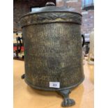 A BRASS LIDDED COAL BUCKET WITH HORSESHOE HANDLES