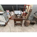 A SINGER TREADLE SEWING MACHINE IN AN OAK CABINET