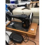 A VINTAGE SINGER SEWING MACHINE COPLETE WITH CASE