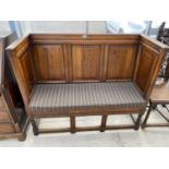 A GEORGE III STYLE OAK ENCLOSED SETTLE WITH PANELLED BACK AND SIDES ON OPEN TURNED BASE, 50" WIDE