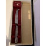 A BOXED SILVER PLATED CHEESE KNIFE