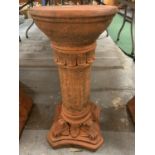 AN ORNATE TERRACOTTA PEDESTAL