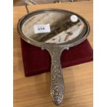 AN EDWARDIAN CONTINENTAL SILVER OVAL EMBOSSED HAND MIRROR