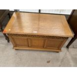 A SMALL REPRODUCTION BLANKET CHEST WITH THREE PANEL FRONT AND CARVED FRIEZE, 33" WIDE