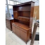 A STAG MINSTREL MAHOGANY DRESSER WITH THREE DOORS, THREE DRAWERS, FOUR UPPER DRAWERS AND ONE DOOR