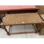 A WOVEN DOUBLE STOOL AND A WICKER LINEN BASKET
