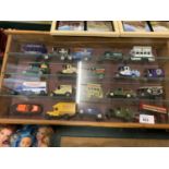 AN ASSORTMENT OF DIE CAST MODEL REPLICA VEHICLES IN A DISPLAY CASE TO INCLUDE A 'JAMESON' VAN AND