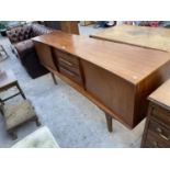 A RETRO TEAK SIDEBOARD WITH SLIGHT INVERTED FRONT, ENCLOSING TWO CUPBOARDS, THREE DRAWERS ON OPEN