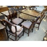 A REGENCY STYLE MAHOGANY AND CROSSBANDED TWIN PEDESTAL DINING TABLE (54x38", +19" EXTENDED), AND SIX